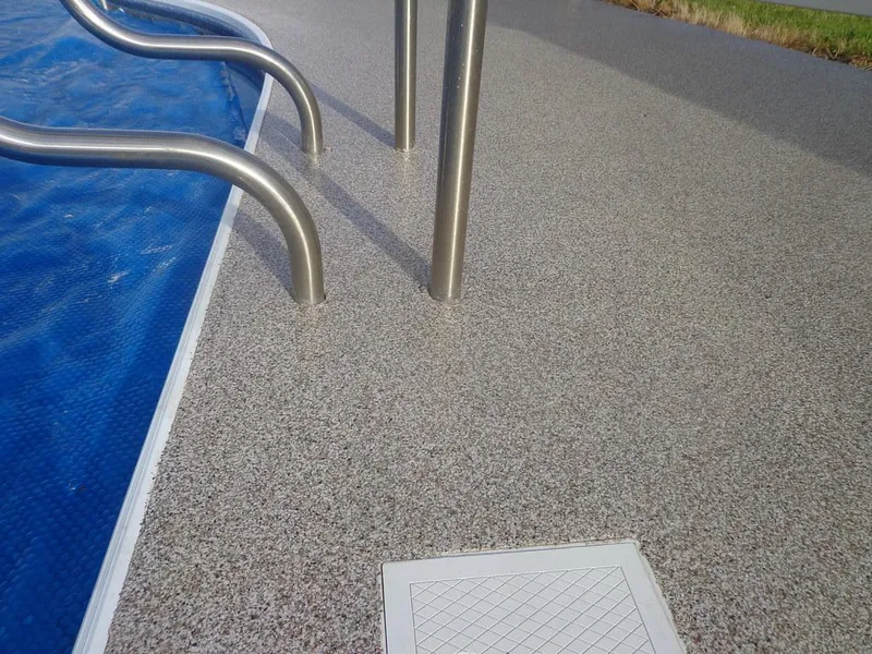 Pool steps and coated deck close up
